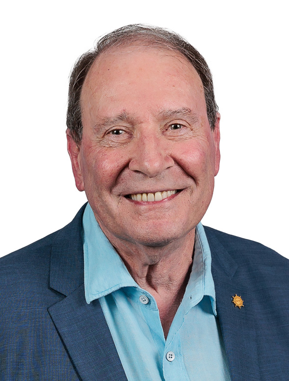 Man looking at camera smiling in a suit